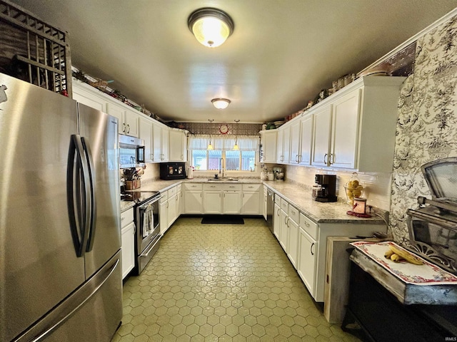 27 N Edwards St, Worthington, IN 47471 - kitchen featuring stainless steel appliances, a sink, and white cabinetry
