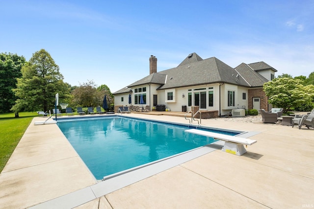 11070 Birch Lake Dr, Granger, IN 46530 - swimming pool with an outdoor hangout area, a patio area, central AC unit, and a diving board