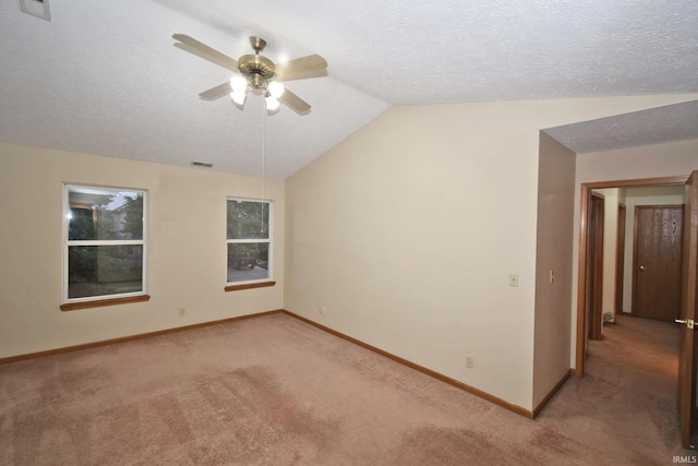 904 Brookridge Ct, Lafayette, IN 47909 - unfurnished room with light carpet, ceiling fan, lofted ceiling, baseboards, and a textured ceiling