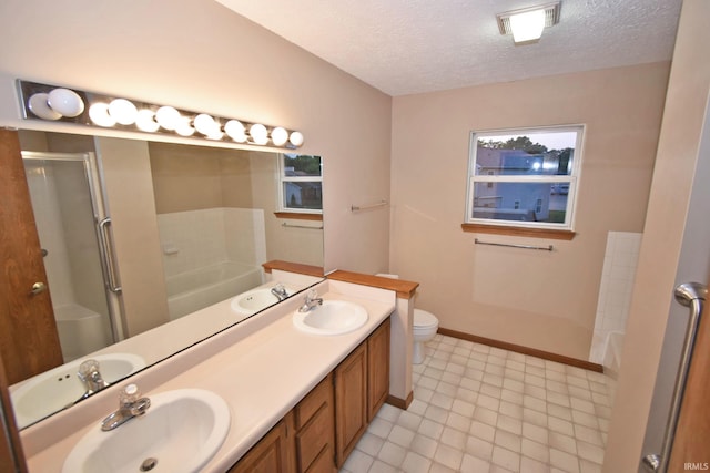 904 Brookridge Ct, Lafayette, IN 47909 - bathroom featuring a stall shower, a bath, a textured ceiling, double vanity, and toilet