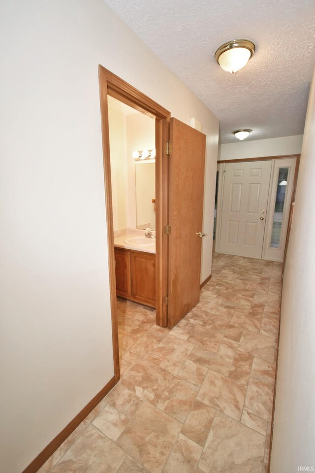904 Brookridge Ct, Lafayette, IN 47909 - hall with a textured ceiling, a sink, and baseboards