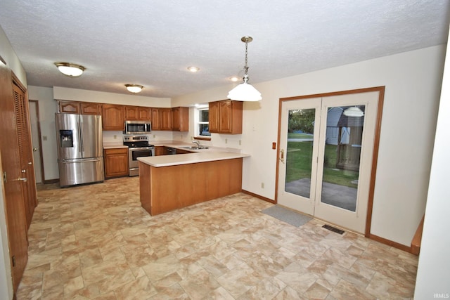 904 Brookridge Ct, Lafayette, IN 47909 - kitchen featuring appliances with stainless steel finishes, a sink, a peninsula, brown cabinetry, and light countertops