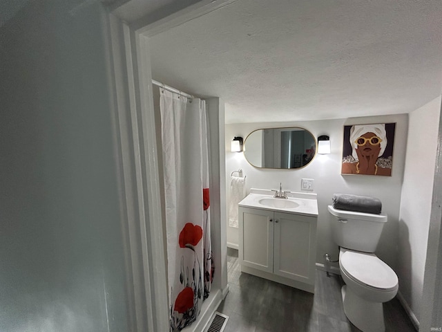 1000 Hartford St, Lafayette, IN 47900 - full bath with toilet, a shower with shower curtain, vanity, wood finished floors, and a textured ceiling