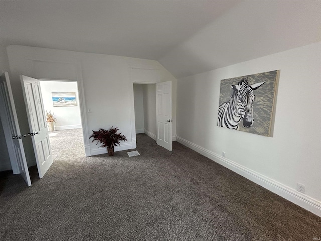 1000 Hartford St, Lafayette, IN 47900 - unfurnished bedroom featuring dark carpet, lofted ceiling, and baseboards
