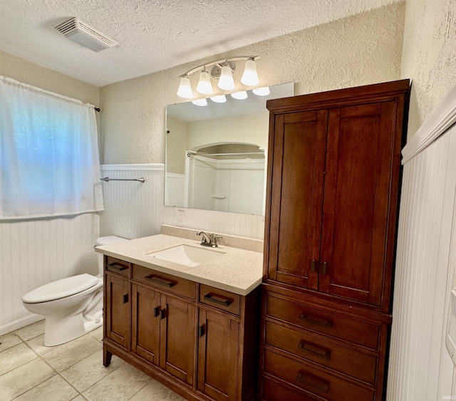 2424 S Webster St, Kokomo, IN 46902 - bathroom featuring a textured wall, a textured ceiling, vanity, wainscoting, and toilet