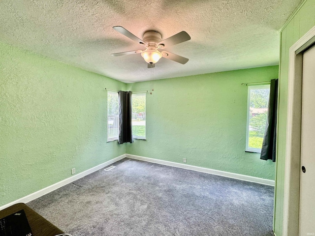 2424 S Webster St, Kokomo, IN 46902 - unfurnished room featuring a textured wall, a ceiling fan, a textured ceiling, carpet flooring, and baseboards