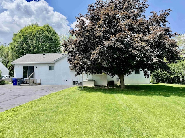 2424 S Webster St, Kokomo, IN 46902 - view of grassy yard with entry steps, driveway, and central air condition unit