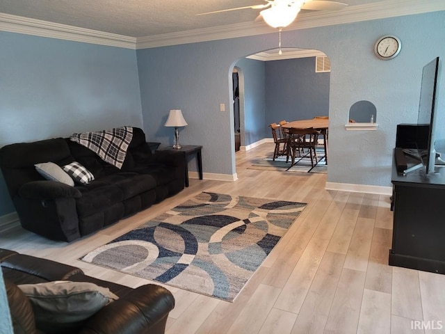 2424 S Webster St, Kokomo, IN 46902 - living area with arched walkways, a ceiling fan, wood finished floors, baseboards, and ornamental molding