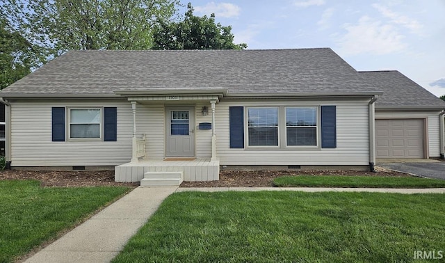 1101 E Boone St, Frankfort, IN 46041 - view of front of property featuring crawl space, a shingled roof, a garage, and a front yard
