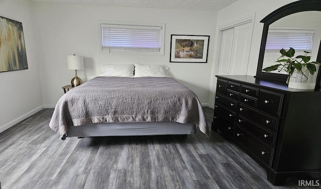 1101 E Boone St, Frankfort, IN 46041 - bedroom featuring wood finished floors, a closet, baseboards, and multiple windows