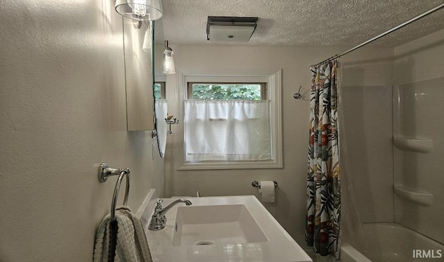 1101 E Boone St, Frankfort, IN 46041 - bathroom featuring shower / bath combo, a textured ceiling, and a sink