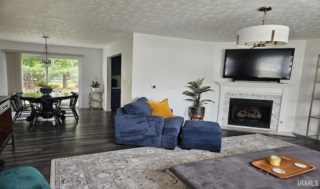 1101 E Boone St, Frankfort, IN 46041 - living room featuring wood finished floors, a high end fireplace, a textured ceiling, and a chandelier