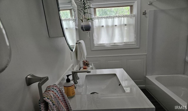 1101 E Boone St, Frankfort, IN 46041 - full bathroom with plenty of natural light, a decorative wall, a sink, and washtub / shower combination