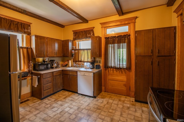 507 N Howard St, Union City, IN 47390 - kitchen with dishwasher, black microwave, a sink, beam ceiling, and freestanding refrigerator