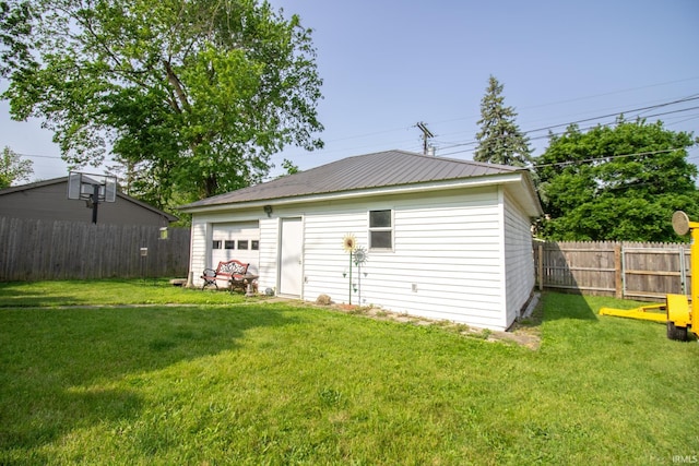 507 N Howard St, Union City, IN 47390 - back of property featuring a garage, metal roof, and an outdoor structure
