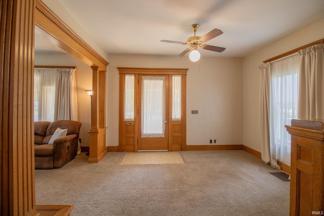 507 N Howard St, Union City, IN 47390 - entrance foyer with light carpet, baseboards, ceiling fan, and decorative columns