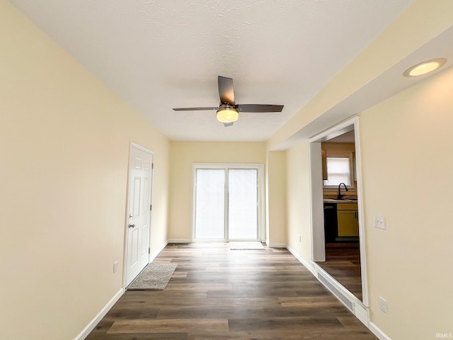 158 Simpson Ave, Elkhart, IN 46516 - unfurnished room featuring a ceiling fan, a sink, wood finished floors, and baseboards