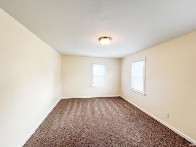 158 Simpson Ave, Elkhart, IN 46516 - empty room featuring dark colored carpet and baseboards