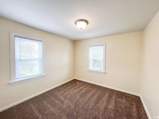 158 Simpson Ave, Elkhart, IN 46516 - unfurnished room with plenty of natural light, dark colored carpet, and baseboards