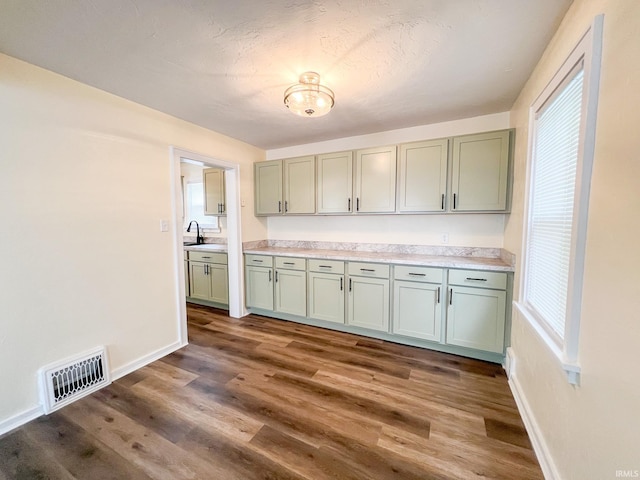 158 Simpson Ave, Elkhart, IN 46516 - kitchen with baseboards, dark wood-type flooring, light countertops, and plenty of natural light
