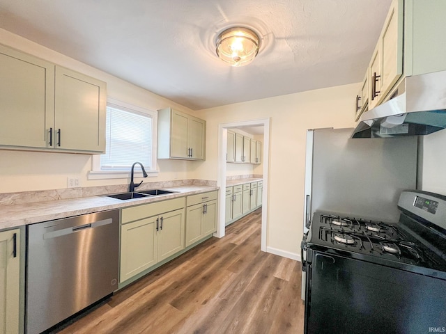 158 Simpson Ave, Elkhart, IN 46516 - kitchen with gas range oven, dishwasher, a sink, under cabinet range hood, and light wood-type flooring