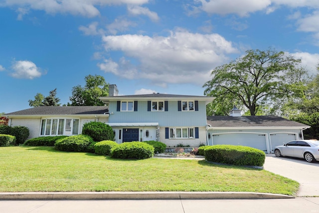 1040 Somerset Ln, Fort Wayne, IN 46805 - split level home with a chimney, brick siding, a garage, and driveway