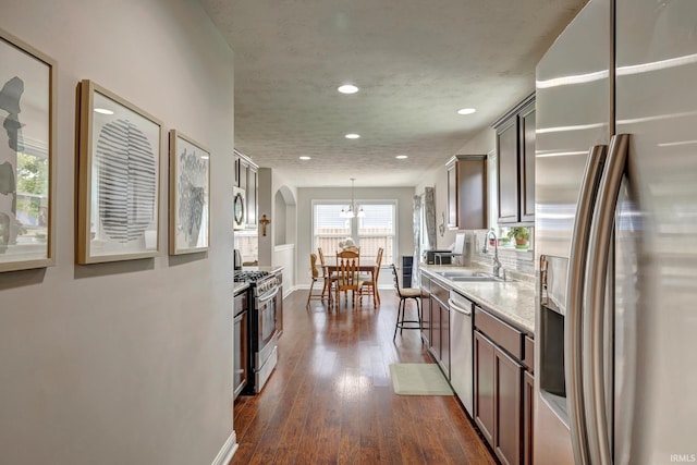 4774 W Hidden Meadow Dr, Bloomington, IN 47404 - kitchen featuring stainless steel appliances, recessed lighting, a sink, light countertops, and dark wood finished floors