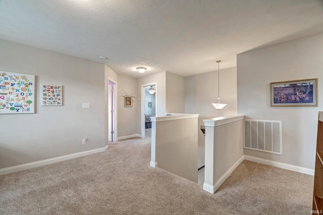 4774 W Hidden Meadow Dr, Bloomington, IN 47404 - hall featuring an upstairs landing, carpet flooring, baseboards, and a textured ceiling