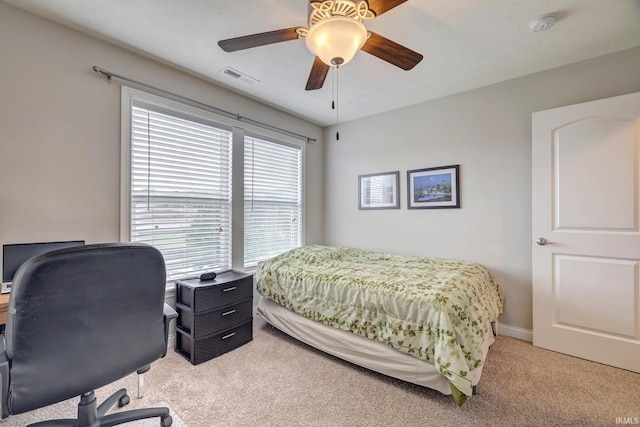4774 W Hidden Meadow Dr, Bloomington, IN 47404 - bedroom with light colored carpet, an office area, ceiling fan, and baseboards