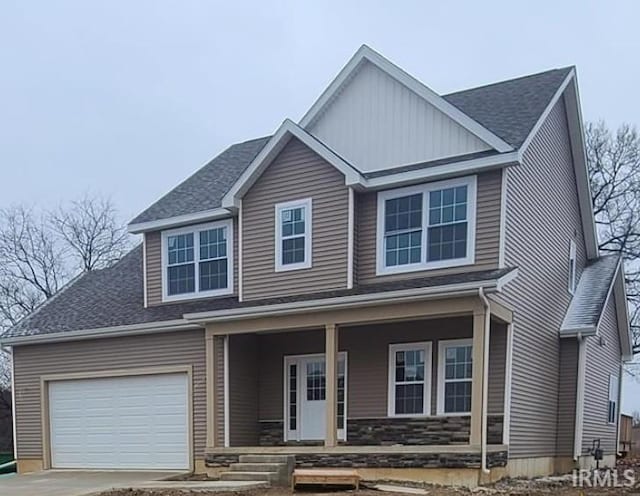 2610 Nature View Dr, Warsaw, IN 46582 - view of front of home with covered porch, roof with shingles, driveway, and an attached garage