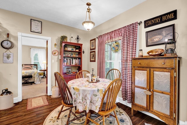 91 Smiths Rd, Mitchell, IN 47446 - dining area featuring healthy amount of natural light, dark wood-type flooring, and baseboards