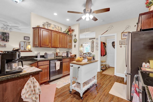 91 Smiths Rd, Mitchell, IN 47446 - kitchen featuring a ceiling fan, appliances with stainless steel finishes, light wood finished floors, dark countertops, and brown cabinets