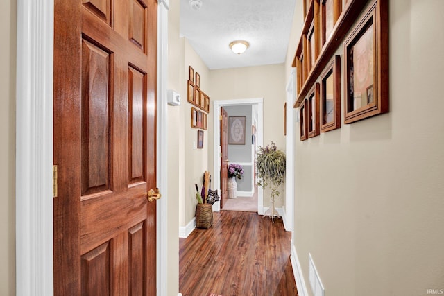 91 Smiths Rd, Mitchell, IN 47446 - hallway featuring dark wood-type flooring, a textured ceiling, and baseboards