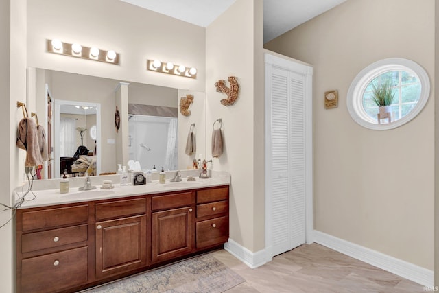 91 Smiths Rd, Mitchell, IN 47446 - ensuite bathroom featuring a closet, double vanity, and baseboards