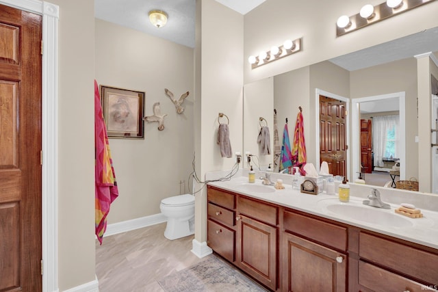 91 Smiths Rd, Mitchell, IN 47446 - bathroom with double vanity, baseboards, and toilet