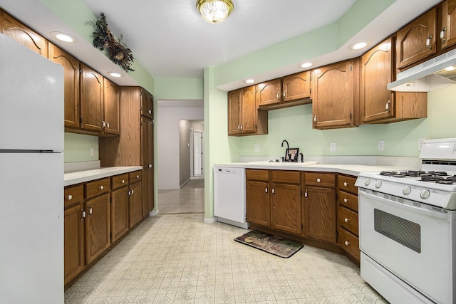 18086 Courtland Dr, South Bend, IN 46637 - kitchen featuring white appliances, a sink, under cabinet range hood, light countertops, and recessed lighting
