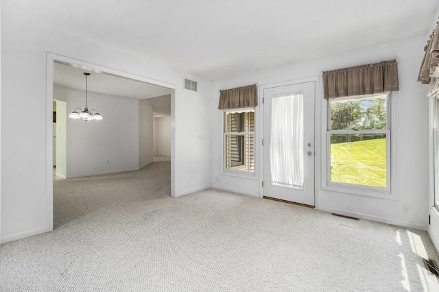 18086 Courtland Dr, South Bend, IN 46637 - unfurnished room with carpet flooring, a chandelier, and baseboards