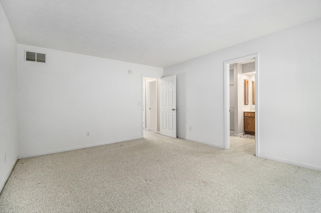 18086 Courtland Dr, South Bend, IN 46637 - unfurnished bedroom with light colored carpet, baseboards, and connected bathroom