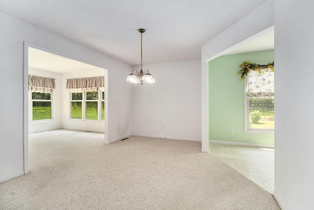 18086 Courtland Dr, South Bend, IN 46637 - carpeted empty room featuring a chandelier and baseboards