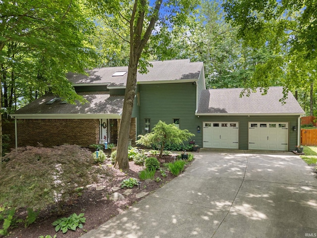 1320 Castle Dr, Lafayette, IN 47905 - view of front of house featuring an attached garage, driveway, and roof with shingles