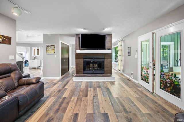 1320 Castle Dr, Lafayette, IN 47905 - living area with wood finished floors, a fireplace, and baseboards