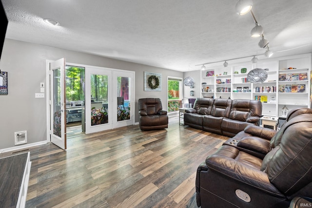 1320 Castle Dr, Lafayette, IN 47905 - living area with french doors, wood finished floors, a textured ceiling, and baseboards