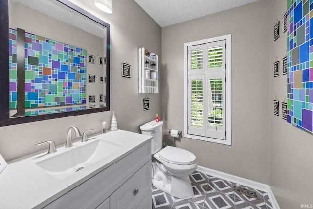 1320 Castle Dr, Lafayette, IN 47905 - bathroom with plenty of natural light, toilet, vanity, and baseboards
