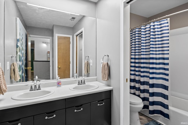 1320 Castle Dr, Lafayette, IN 47905 - bathroom featuring double vanity, toilet, and shower / bath combo with shower curtain