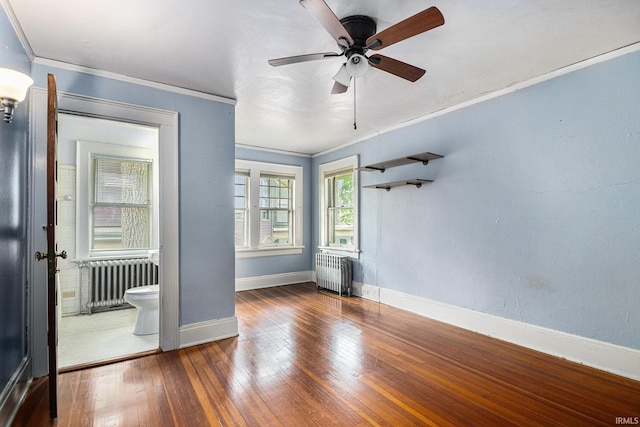 706 Park Ave, South Bend, IN 46616 - empty room featuring radiator heating unit, ornamental molding, hardwood / wood-style floors, and a ceiling fan