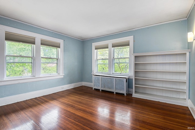706 Park Ave, South Bend, IN 46616 - empty room with radiator, hardwood / wood-style floors, baseboards, and ornamental molding