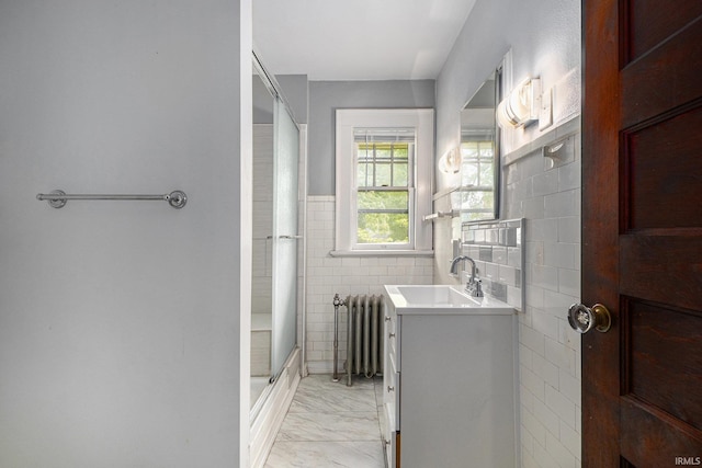706 Park Ave, South Bend, IN 46616 - full bathroom with radiator heating unit, marble look tiles, vanity, an enclosed shower, and tile walls