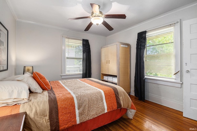 706 Park Ave, South Bend, IN 46616 - bedroom featuring wood finished floors, multiple windows, ornamental molding, baseboards, and a ceiling fan
