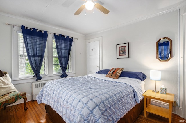 706 Park Ave, South Bend, IN 46616 - bedroom featuring wood finished floors, crown molding, a ceiling fan, radiator, and baseboards