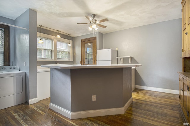 706 Park Ave, South Bend, IN 46616 - kitchen featuring washer / clothes dryer, freestanding refrigerator, ceiling fan, and dark wood-type flooring